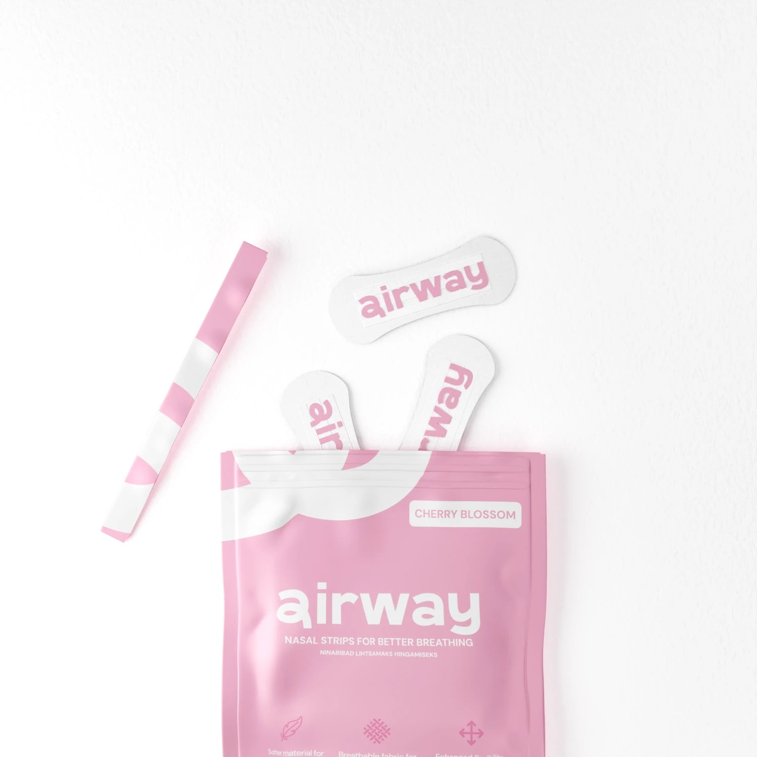 Pink 'airway' nasal strip packaging with three strips on a white background