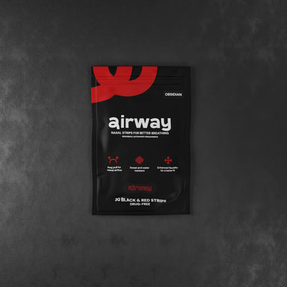 Black and red packaging of airway nasal strips on a dark gray background