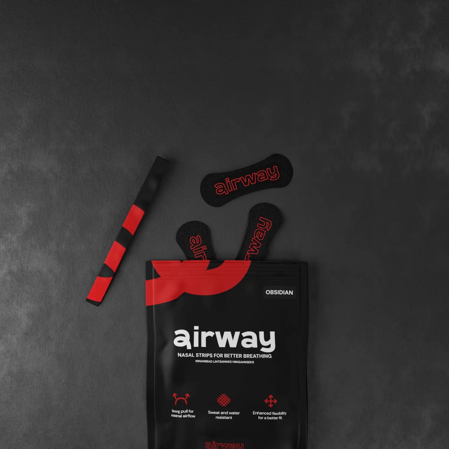 Airway nasal strip packaging with strips on a dark gray background