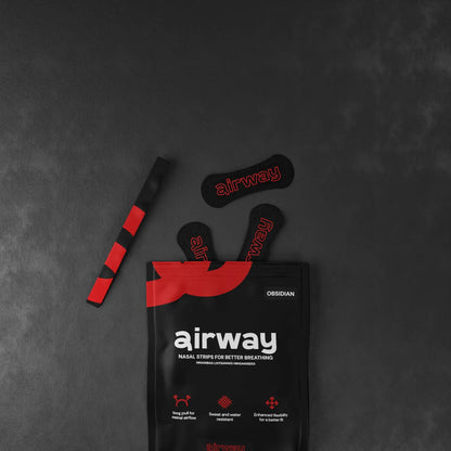 Airway nasal strip packaging with strips on a dark gray background